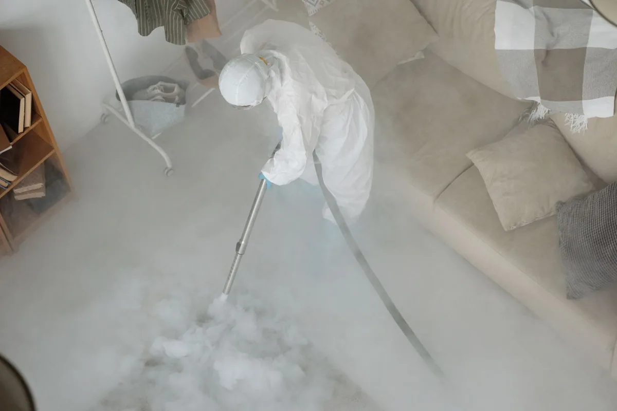 Biohazard cleanup technician in protective equipment, Ingram, TX